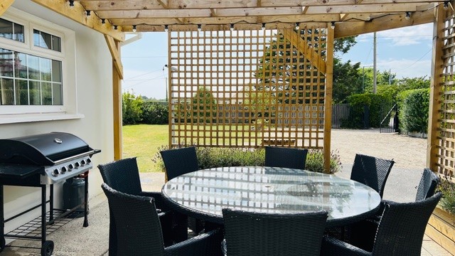 Patio seating and barbecue at Dash Bungalow