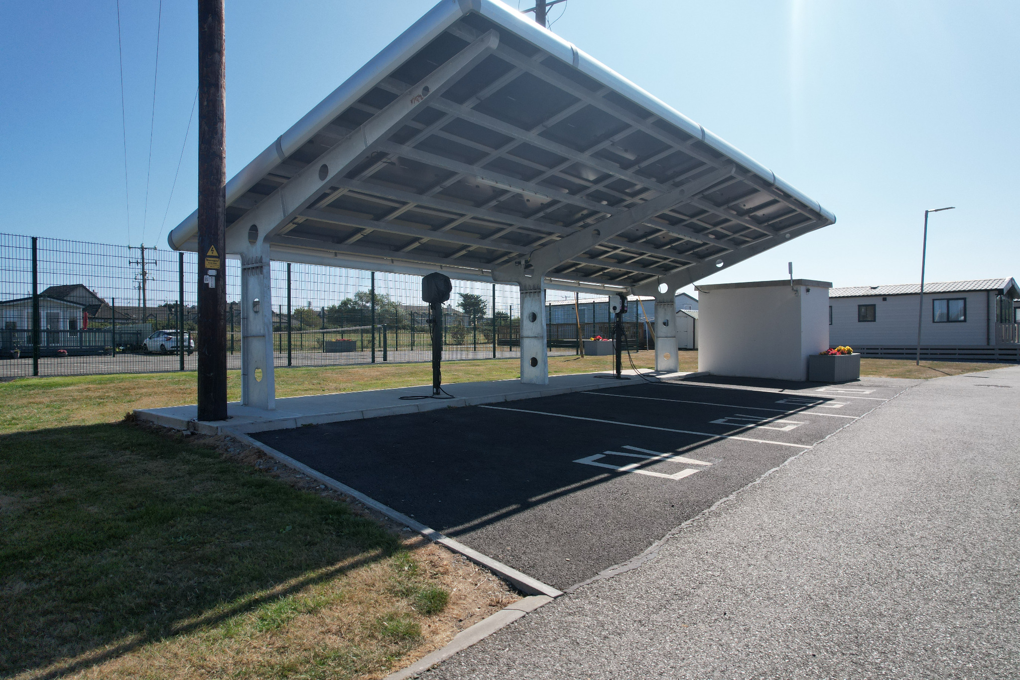 Electric car charging bays beneath a canopy at Central Holiday Park Rosslare
