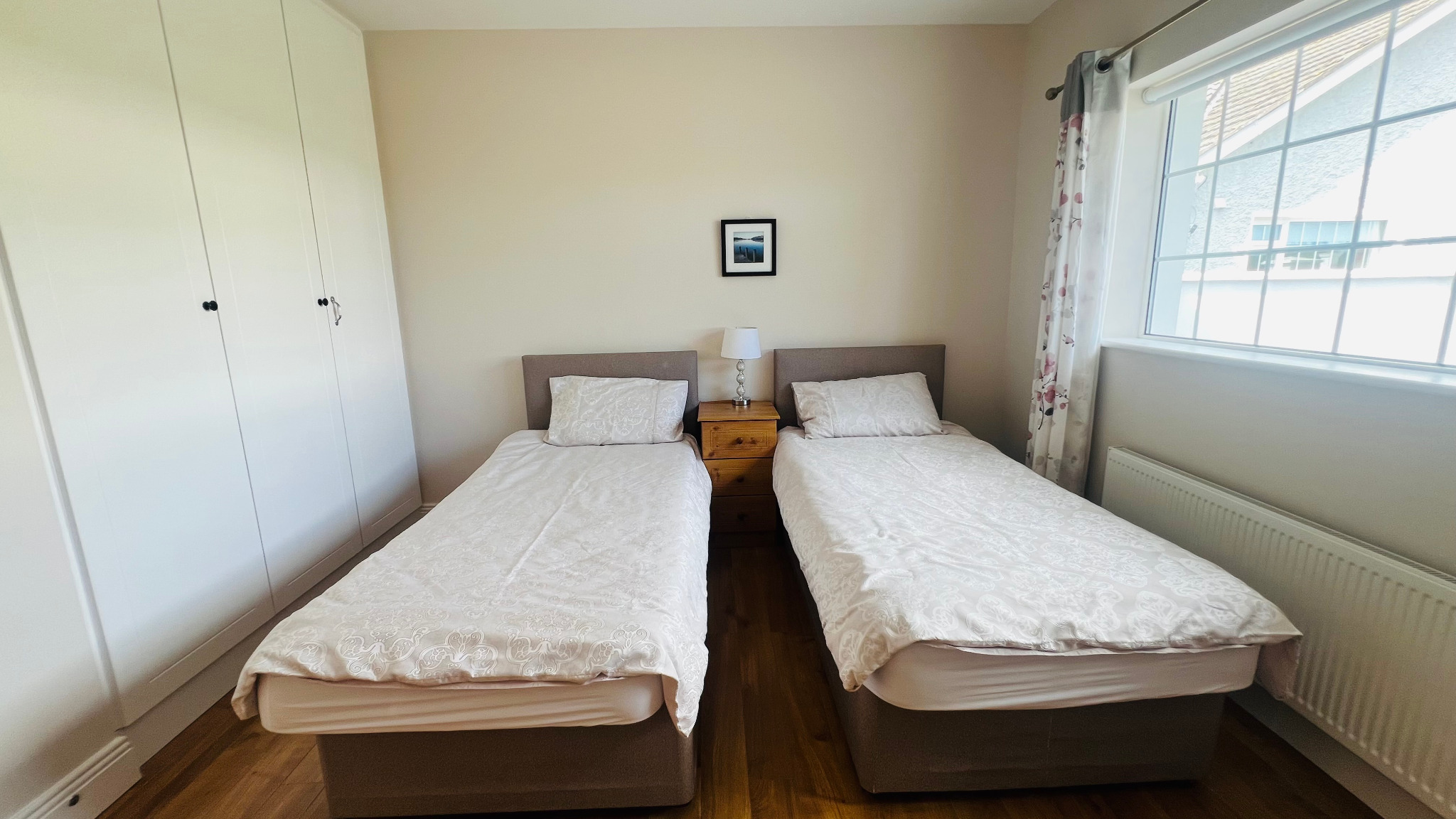 Twin bedroom and wardrobe at Ellington Lodge